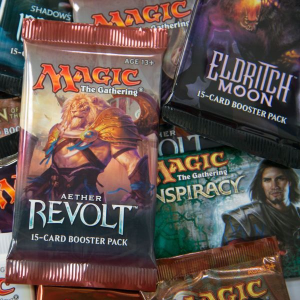 Booster packs showing different Houston MTG sets.